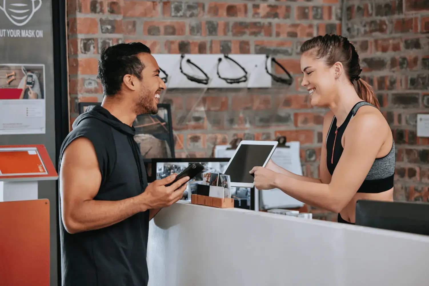 Man signing up for a membership at a boutique gym front desk